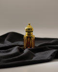 Decorative bottle with gold and red patterns on a gray background